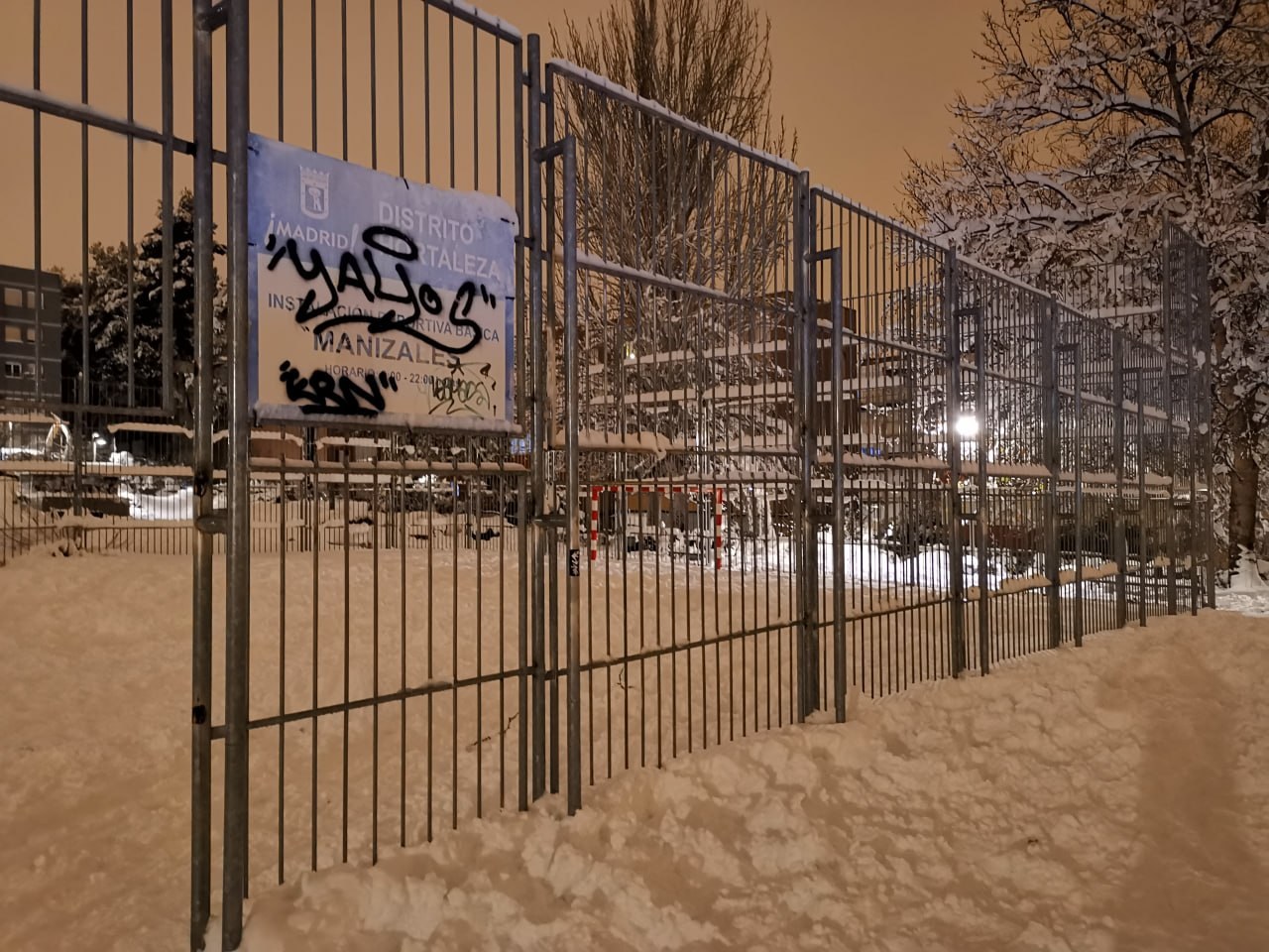 Snow-covered basketball court in Manizales, Madrid, at night