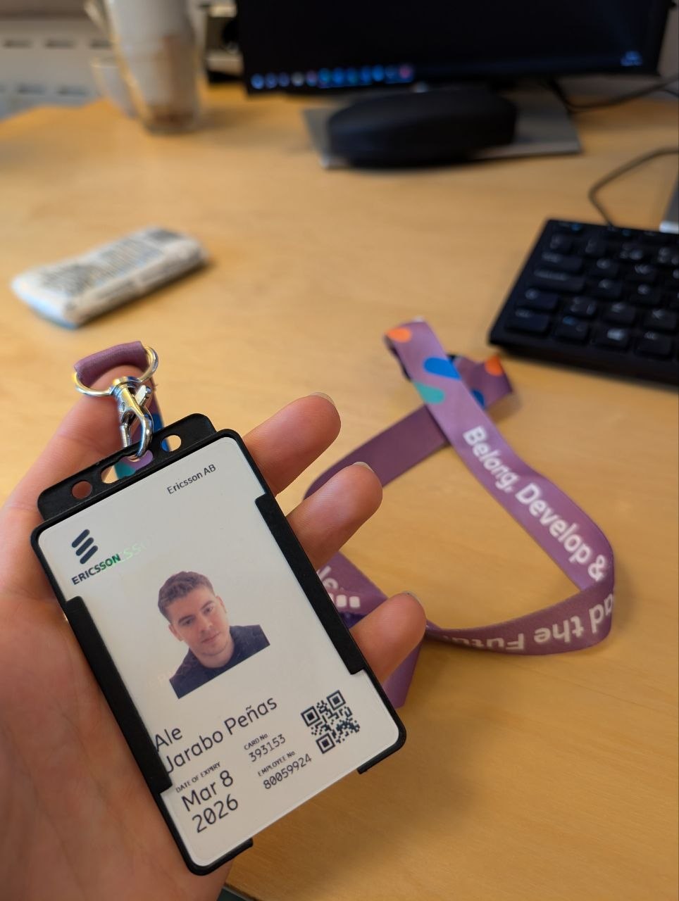 My Ericsson employee badge on the Belong, Develop and Lead the Future lanyard