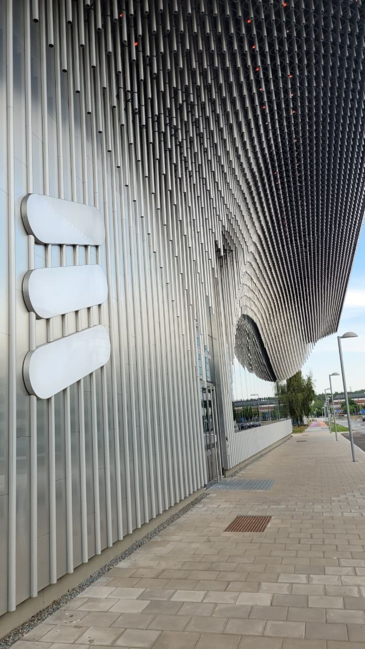 The Ericsson building facade with its wave-like pipe canopy