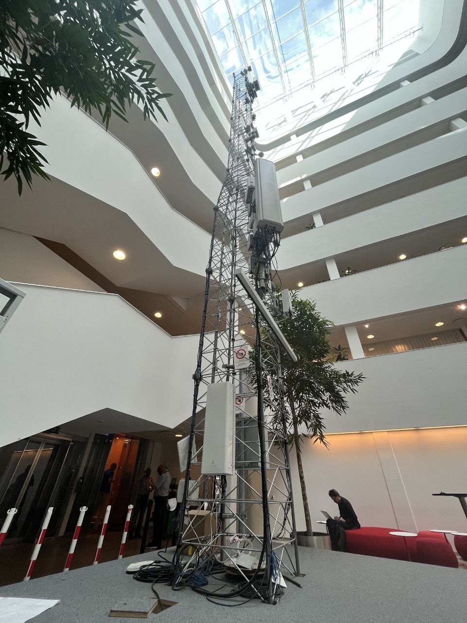 Indoor telecom tower with panel antennas in the office atrium