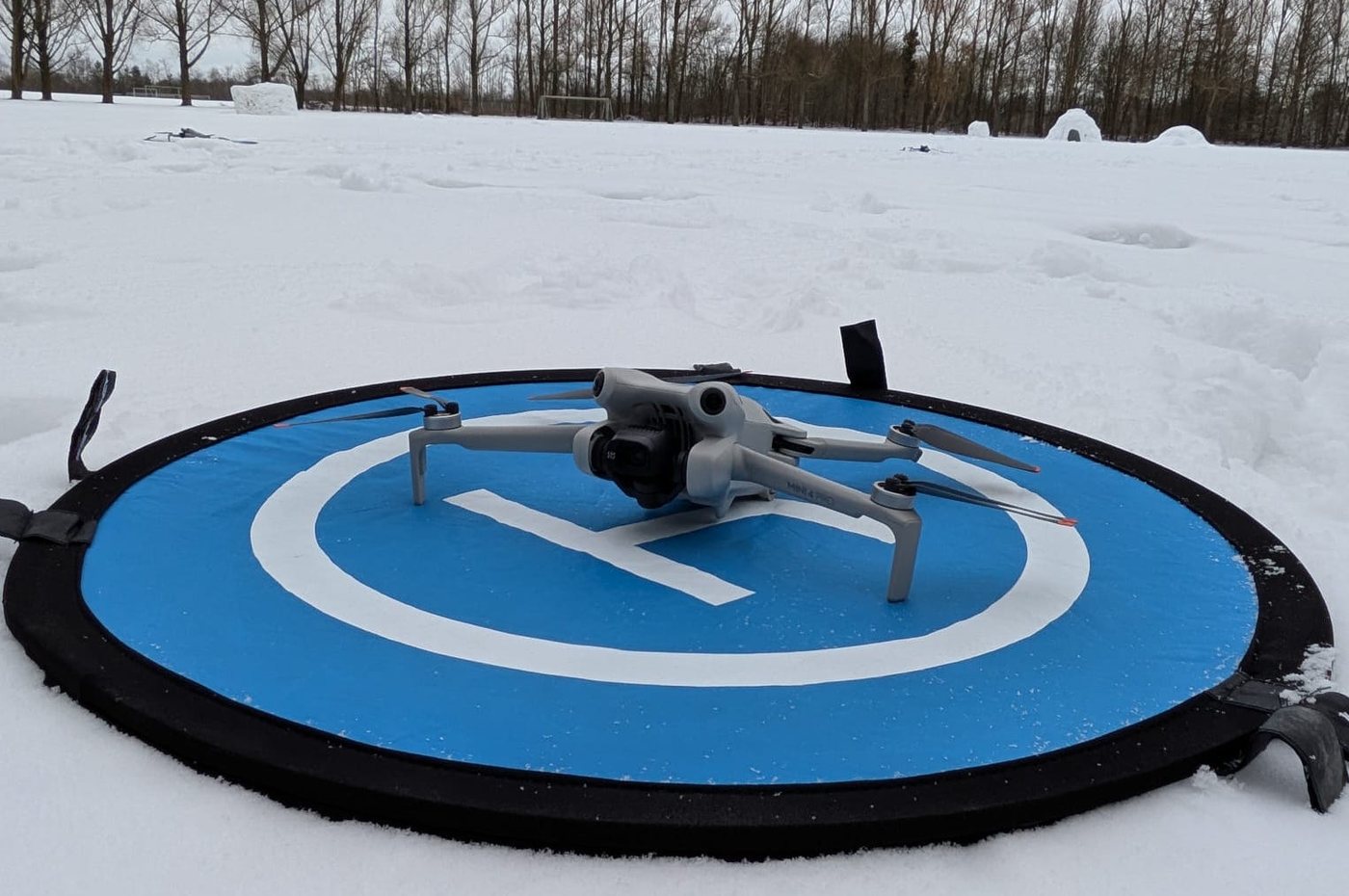 A DJI Mini 4 Pro drone ready for takeoff.