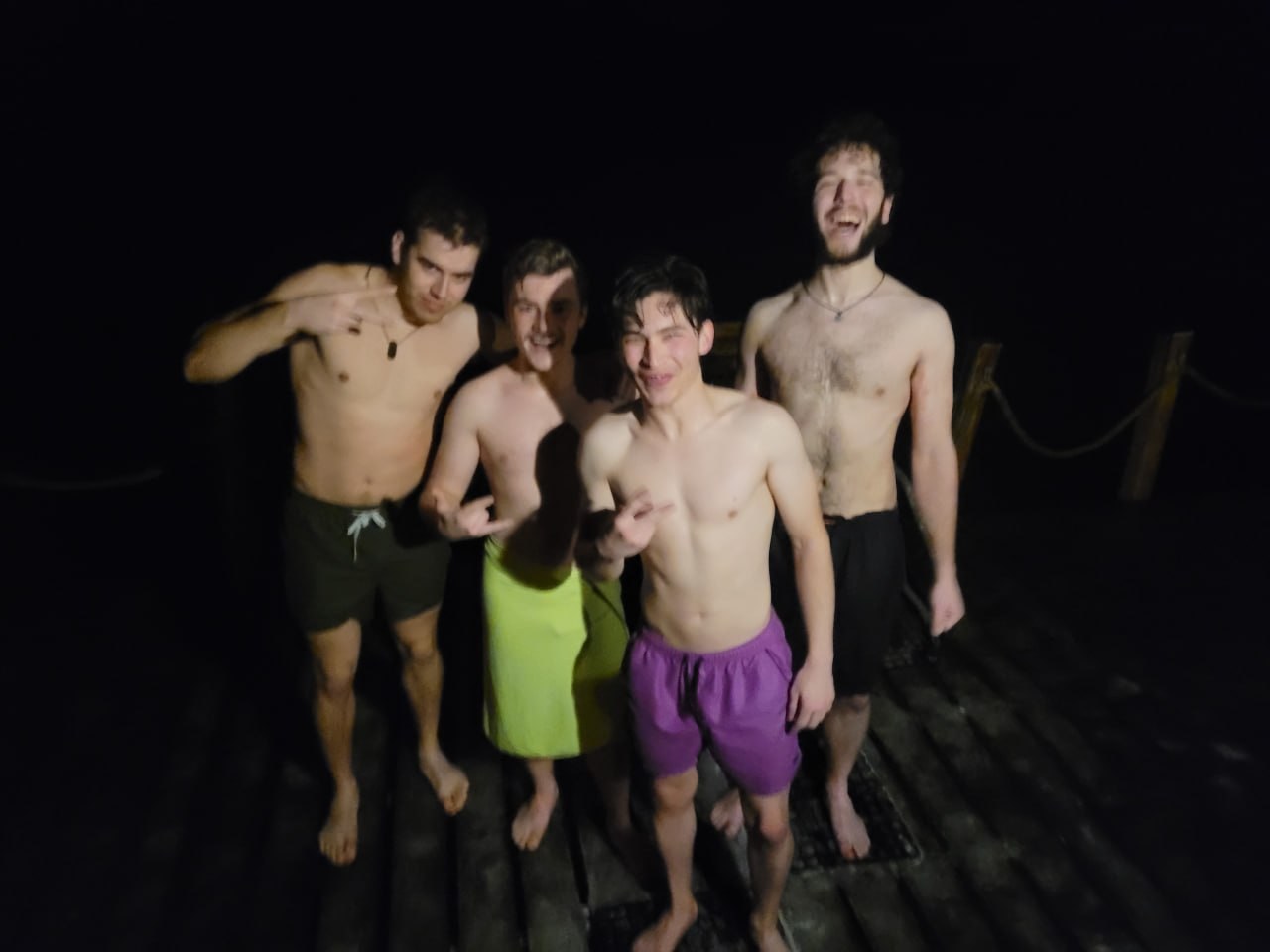 Night swim from a wooden pier with friends
