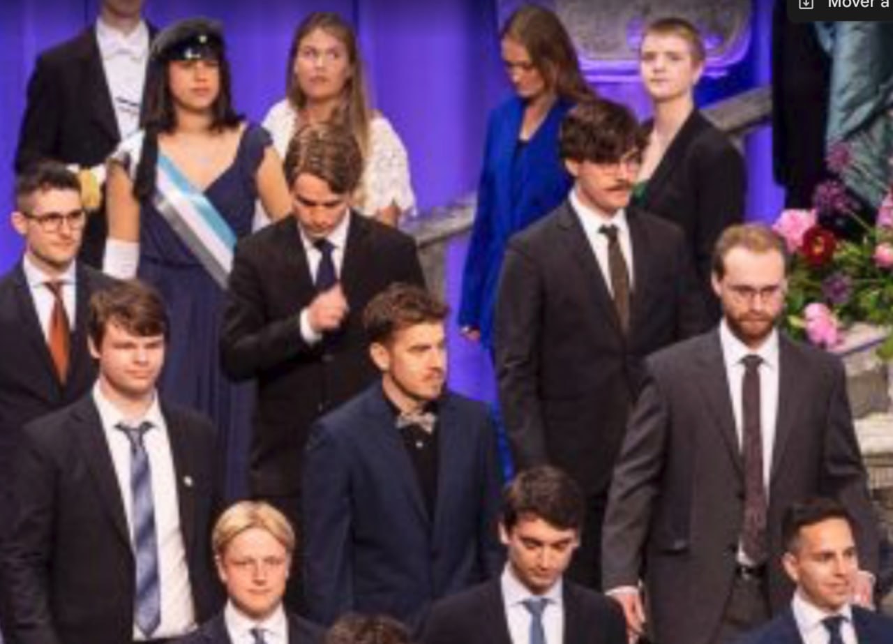 The group coming down the staircase at the ceremony