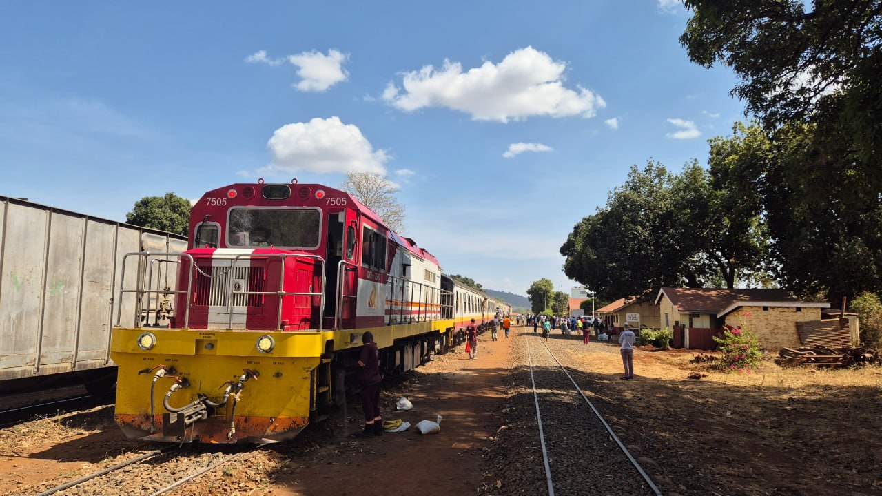 Red and yellow train engine arriving on Nairobi-Nanyuki railway line